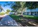 Inviting courtyard with lush green lawn, mature trees, and a charming seating area at 815 N Hayden Rd # B109, Scottsdale, AZ 85257