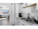 Well-lit kitchen featuring a stainless steel sink, white cabinetry and marble countertops at 815 N Hayden Rd # B109, Scottsdale, AZ 85257