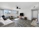 Bright living room featuring wood-look flooring, a ceiling fan, and views at 815 N Hayden Rd # B109, Scottsdale, AZ 85257