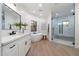 Bright bathroom featuring a soaking tub, marble countertops, modern fixtures, and a glass door shower at 8254 E Juan Tabo Rd, Scottsdale, AZ 85255