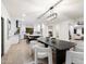 Dining room view with a large dining table, modern lighting, and an open view to kitchen at 8254 E Juan Tabo Rd, Scottsdale, AZ 85255