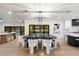 Light and bright dining room featuring modern table set, light fixture and slider door views of pool at 8254 E Juan Tabo Rd, Scottsdale, AZ 85255