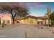 Inviting single-story home featuring desert landscaping, covered entryway, and attached garage at 8254 E Juan Tabo Rd, Scottsdale, AZ 85255