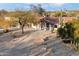 Inviting front exterior with a circular driveway and grand entrance, surrounded by desert flora at 8254 E Juan Tabo Rd, Scottsdale, AZ 85255