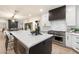 Open kitchen featuring an island with a waterfall countertop and stainless steel appliances at 8254 E Juan Tabo Rd, Scottsdale, AZ 85255