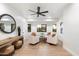 Sitting room with tile floors, a round mirror and backyard views through three windows at 8254 E Juan Tabo Rd, Scottsdale, AZ 85255