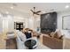 Bright living room featuring modern decor, fireplace, and sleek ceiling fan at 8254 E Juan Tabo Rd, Scottsdale, AZ 85255