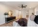 Bright bedroom with modern decor, a ceiling fan, and a view of the walk-in closet at 8254 E Juan Tabo Rd, Scottsdale, AZ 85255