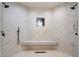 Walk-in shower featuring marble tile walls, a built-in bench, and rainfall shower heads at 8254 E Juan Tabo Rd, Scottsdale, AZ 85255