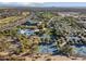 Extensive aerial view showcasing the community amenities including pools, tennis courts, and a modern clubhouse at 8506 W Trenton Ct, Florence, AZ 85132