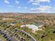 Aerial view of the community center with a splash pad, pool, lush landscaping and a spacious parking lot at 8506 W Trenton Ct, Florence, AZ 85132