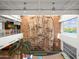 Indoor climbing wall with natural light near the recreation center, with a palm tree in the foyer at 8506 W Trenton Ct, Florence, AZ 85132