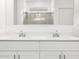 Modern bathroom with a double vanity, chrome fixtures and a view of the glass enclosed shower at 8555 W Trenton Ct, Florence, AZ 85132