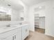 Beautiful primary bathroom featuring double sinks, tiled floors, and glass-enclosed shower and a walk-in closet at 8555 W Trenton Ct, Florence, AZ 85132