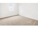 Neutral-toned carpeted bedroom featuring a bright window at 8555 W Trenton Ct, Florence, AZ 85132