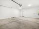Clean two-car garage with sealed concrete flooring and overhead door system at 8555 W Trenton Ct, Florence, AZ 85132
