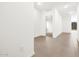Bright hallway with neutral-toned tile flooring that transitions into carpeted area at 8555 W Trenton Ct, Florence, AZ 85132