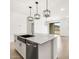 Kitchen island with stainless steel sink, granite countertops, and modern fixtures; leads to backyard access at 8555 W Trenton Ct, Florence, AZ 85132