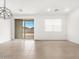 Bright living room featuring neutral tile flooring and sliding glass doors at 8555 W Trenton Ct, Florence, AZ 85132