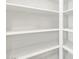 An open, empty, and bright pantry with rows of white shelves, perfect for organization at 8555 W Trenton Ct, Florence, AZ 85132
