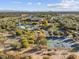 Expansive aerial view of community amenities featuring pool, tennis courts, and clubhouse with mountain views at 8560 W Trenton Ct, Florence, AZ 85132