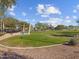 View of the green and spacious dog park with shade structure and desert landscaping in a residential area at 8560 W Trenton Ct, Florence, AZ 85132