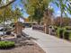 Community park view of a bridge and lake with shade structure, barbecue, and desert landscaping at 8560 W Trenton Ct, Florence, AZ 85132