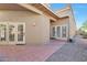 Home exterior featuring an outdoor patio with tile flooring and backyard access through double doors at 9372 E Aster Dr, Scottsdale, AZ 85260