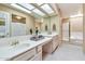 Well-lit bathroom featuring dual sinks, vanity lighting, and a separate shower and bathtub at 9372 E Aster Dr, Scottsdale, AZ 85260