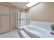 Elegant bathroom with a soaking tub, glass-enclosed shower, and neutral-toned decor at 9372 E Aster Dr, Scottsdale, AZ 85260