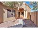 Inviting home entrance with decorative pillars, a tiled walkway, and low-maintenance desert landscaping at 9372 E Aster Dr, Scottsdale, AZ 85260