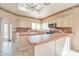 Bright kitchen with a skylight, tile countertops, white cabinets, and ample counter space at 9372 E Aster Dr, Scottsdale, AZ 85260