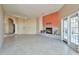 Spacious living room with a tiled fireplace, neutral walls, and access to the outdoors at 9372 E Aster Dr, Scottsdale, AZ 85260