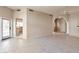 An open-concept living room with tile flooring, a ceiling fan, and an arched doorway at 9372 E Aster Dr, Scottsdale, AZ 85260