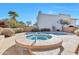 Backyard showcasing pool and spa with decorative tile, surrounded by mature desert landscaping at 9372 E Aster Dr, Scottsdale, AZ 85260