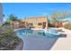 Beautiful backyard pool with a spa, lush landscaping, and desert surroundings at 9372 E Aster Dr, Scottsdale, AZ 85260