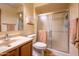 Bathroom with shower featuring glass doors, a wood vanity, and neutral color palette at 100 N Vulture Mine Rd # 103, Wickenburg, AZ 85390