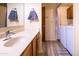 Bathroom with a modern wood vanity, basin sink, and convenient laundry area at 100 N Vulture Mine Rd # 103, Wickenburg, AZ 85390