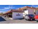 Exterior view of covered parking spaces; cars parked under a carport and building sign present at 100 N Vulture Mine Rd # 103, Wickenburg, AZ 85390