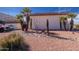 Exterior view of property showcasing desert landscaping and palm trees enhancing curb appeal at 100 N Vulture Mine Rd # 103, Wickenburg, AZ 85390