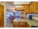 Open kitchen overlooks a dining area and includes wood cabinets with laminate countertops at 100 N Vulture Mine Rd # 103, Wickenburg, AZ 85390