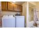 Laundry room with a pair of modern washing machines and a combined tub and shower at 100 N Vulture Mine Rd # 103, Wickenburg, AZ 85390