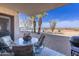 Outdoor patio area with a table and chairs with gravel, plants, and swimming pool in the background at 100 N Vulture Mine Rd # 103, Wickenburg, AZ 85390