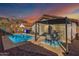 Private backyard oasis with a pool, cozy patio seating, and mountain backdrop, perfect for relaxation at 1146 N 89Th St, Mesa, AZ 85207