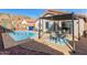 Beautiful backyard featuring a pool, patio with dining set, and mountain views, ideal for outdoor entertaining at 1146 N 89Th St, Mesa, AZ 85207