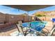 Inviting backyard with a refreshing pool, outdoor dining area, and privacy wall, perfect for relaxation at 1146 N 89Th St, Mesa, AZ 85207