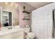 Well-lit bathroom with ruffled shower curtain, decorative shelves, and a white vanity at 1146 N 89Th St, Mesa, AZ 85207