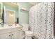 Colorful bathroom features a polka dot curtain and light green walls at 1146 N 89Th St, Mesa, AZ 85207