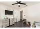 This bedroom features wood floors and a ceiling fan, with a changing table at 1146 N 89Th St, Mesa, AZ 85207