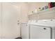 Functional laundry room equipped with modern Samsung washer and dryer and overhead shelving at 1146 N 89Th St, Mesa, AZ 85207